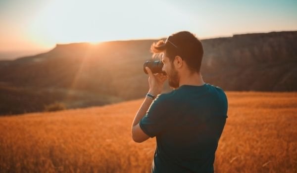 Image of a guy taking landscape photographs