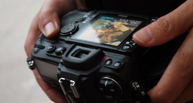 Image of a person showing the dslr display
