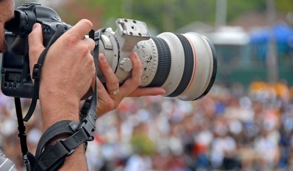 Image of a person taking photos with telephoto