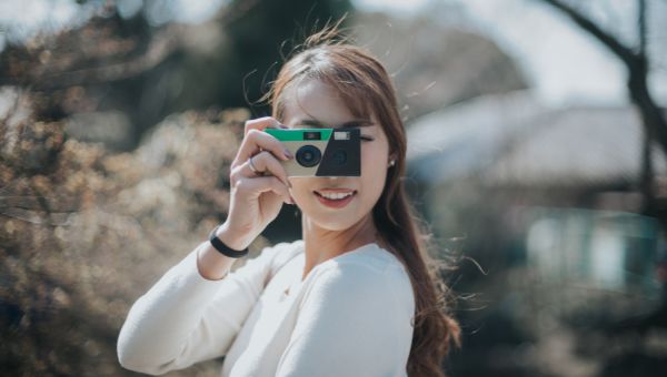 Image of a woman using Disposable Camera