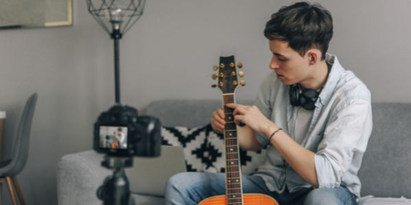 Image of boy teaching guitar