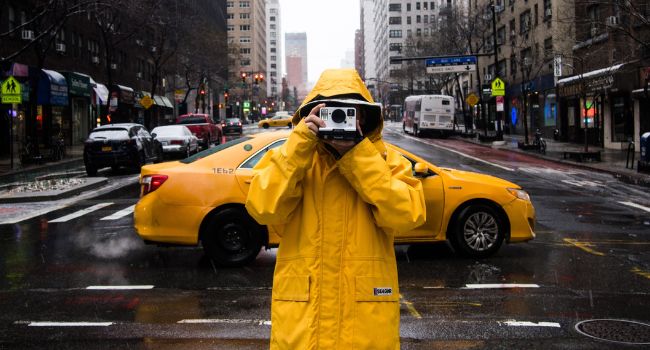 izzy taking street pictures in yellow raincoat