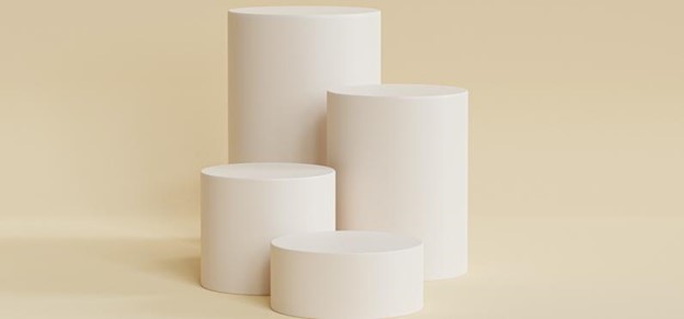 four spray painted round boxes