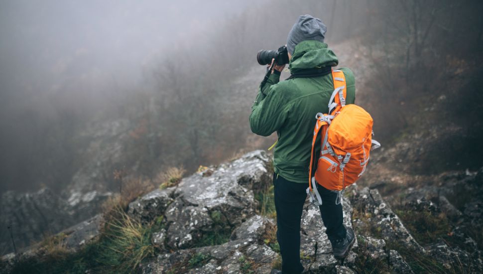 image of a photographer on mountains taking pics